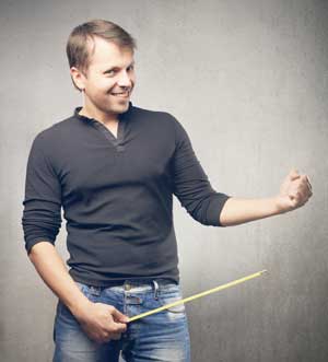 A man who is motivated to increase penis length and is holding a ruler next to his crotch