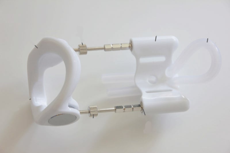 the white, plastic base part of the pro-extender penis extender