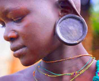 Tribal human with elongated earlobes due to cell hyperplasia.